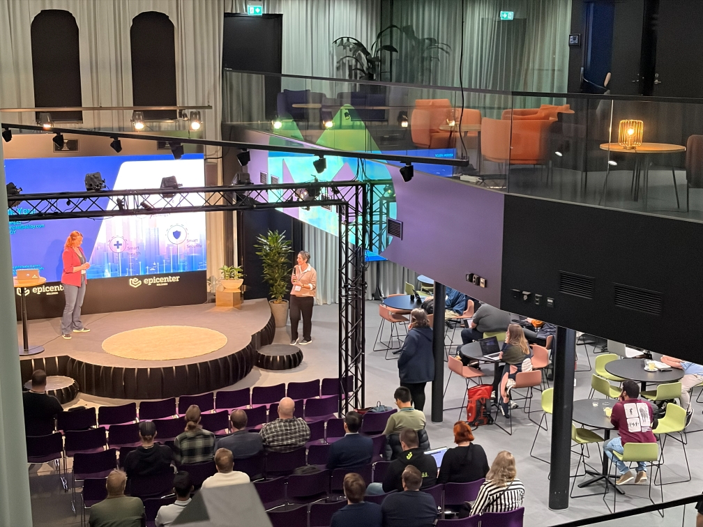 Hanna Sillanpää presenting and Claire Barrett MCing at APIOps Helsinki 2026